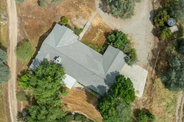 an aerial view of a house with a yard and garden