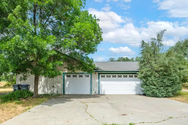 a view of a house with a yard and garage