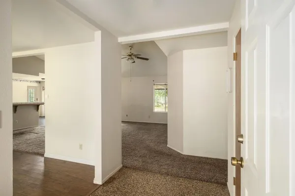 a view of a room with wooden floor and a bathroom