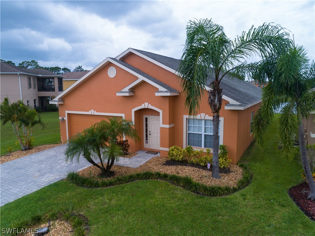 8249 Silver Birch Way Lehigh Acres, FL 33971 - Photo 1 of 19 a front view of a house with a yard and porch