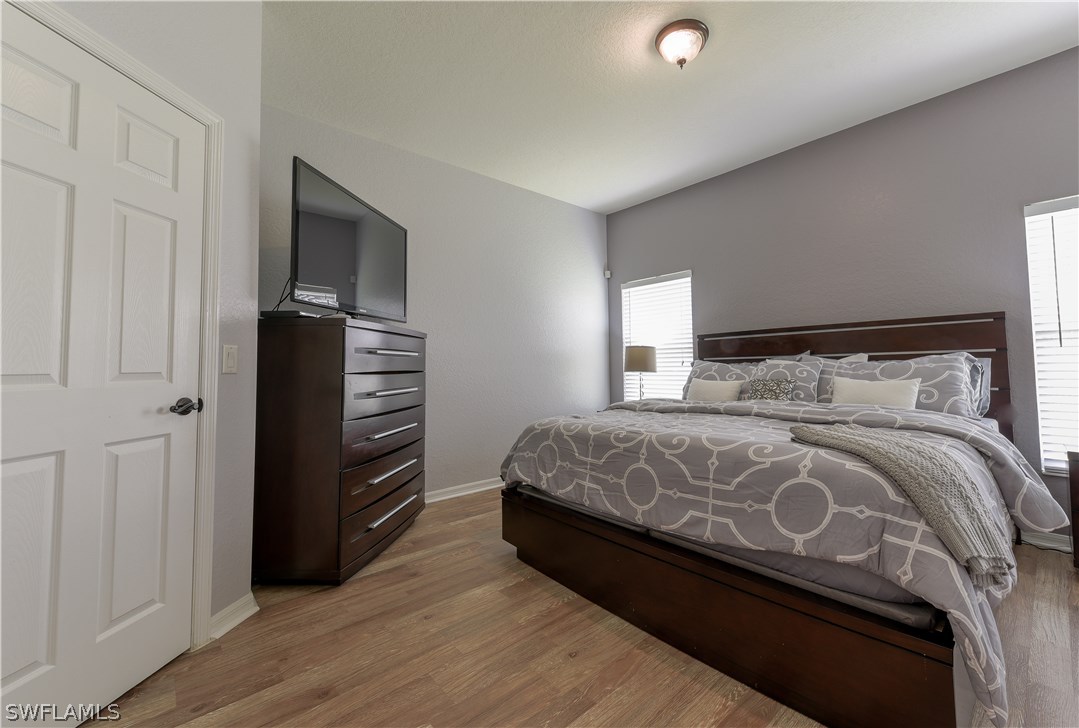 8249 Silver Birch Way Lehigh Acres, FL 33971 - Photo 11 of 19 a bedroom with a bed and a television