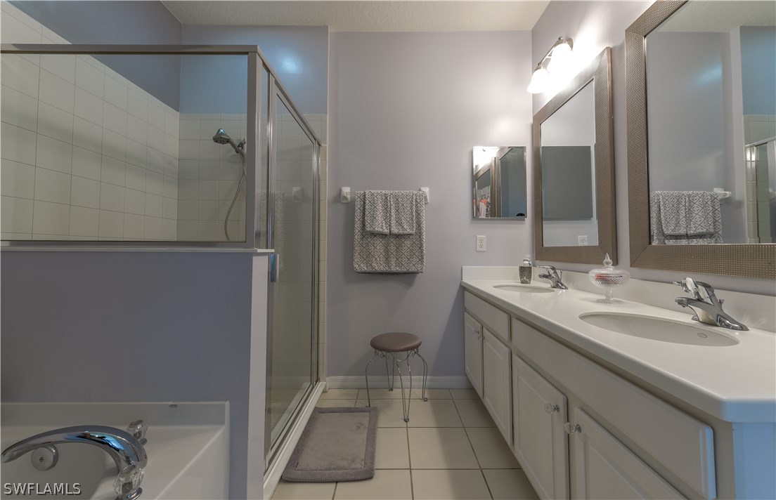 8249 Silver Birch Way Lehigh Acres, FL 33971 - Photo 12 of 19 a bathroom with a granite countertop sink a toilet and a mirror