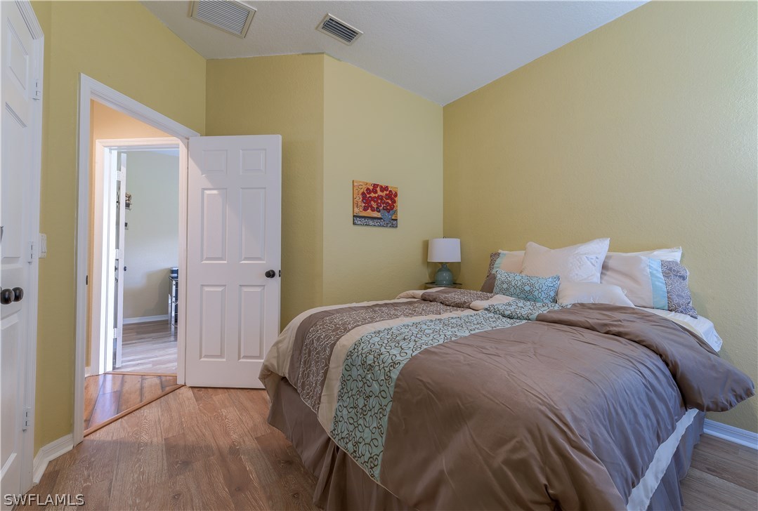 8249 Silver Birch Way Lehigh Acres, FL 33971 - Photo 14 of 19 a bedroom with a bed and a shower