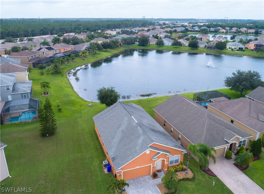 8249 Silver Birch Way Lehigh Acres, FL 33971 - Photo 2 of 19 an aerial view of a house with a lake view