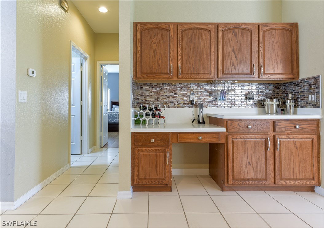 8249 Silver Birch Way Lehigh Acres, FL 33971 - Photo 5 of 19 a kitchen with stainless steel appliances granite countertop a sink and cabinets