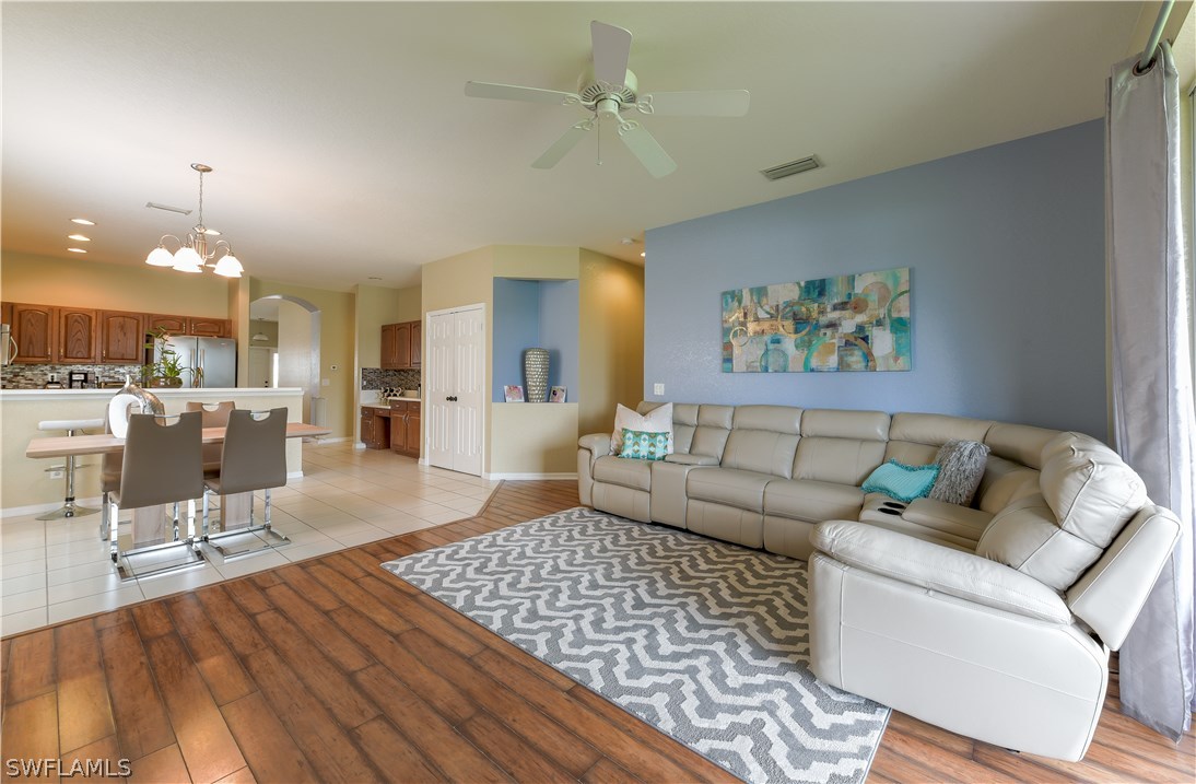 8249 Silver Birch Way Lehigh Acres, FL 33971 - Photo 6 of 19 a living room with furniture and a dining table with wooden floor