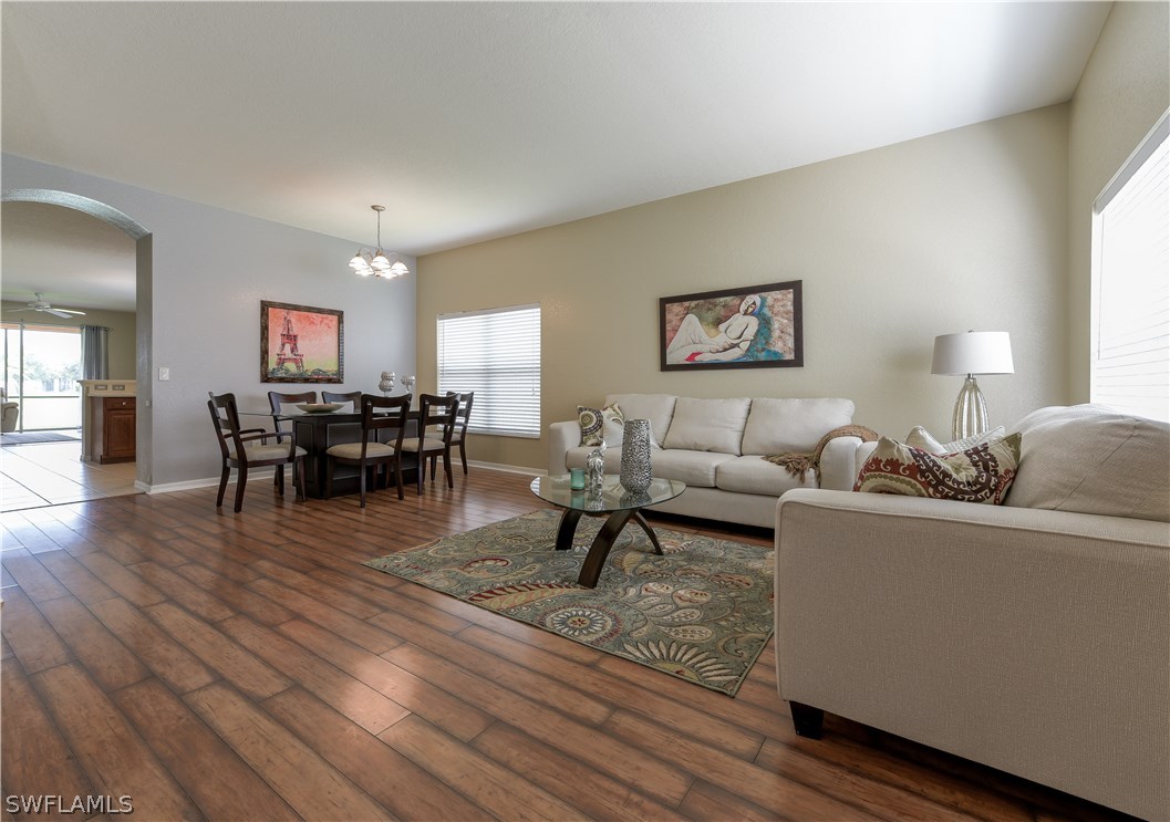 8249 Silver Birch Way Lehigh Acres, FL 33971 - Photo 8 of 19 a living room with furniture and wooden floor