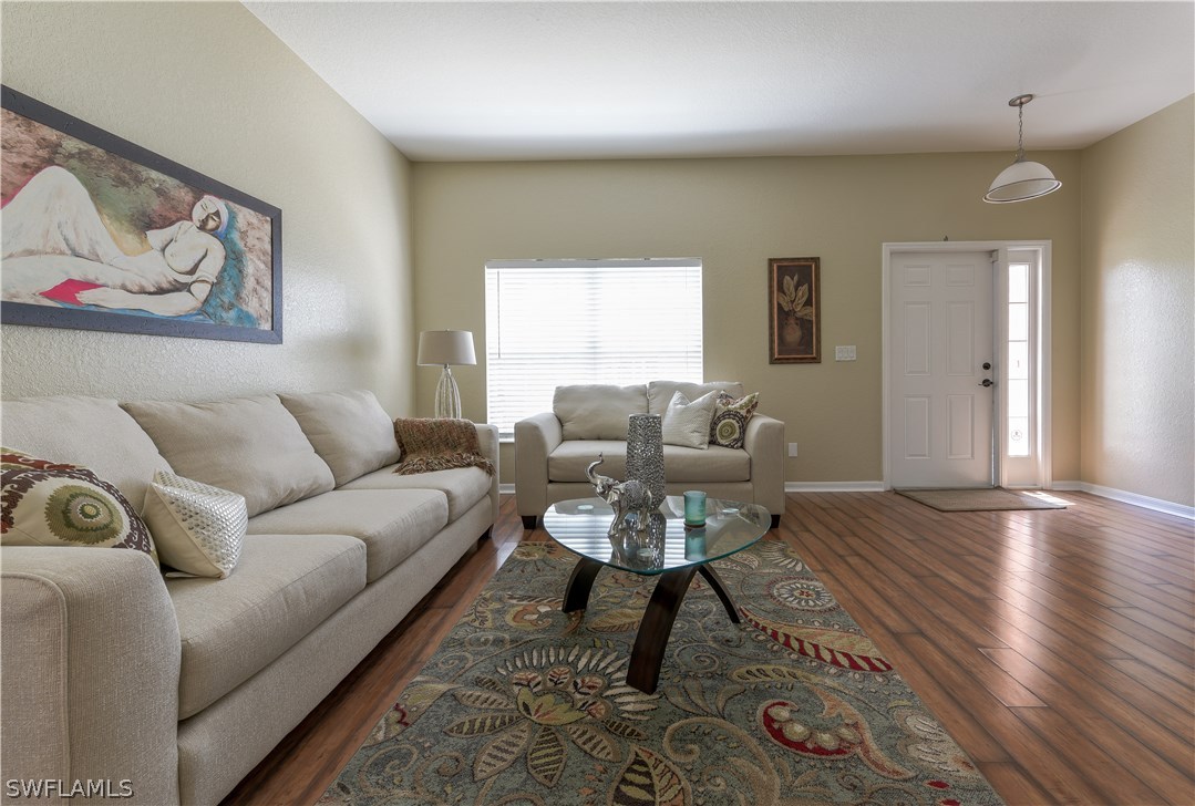 8249 Silver Birch Way Lehigh Acres, FL 33971 - Photo 9 of 19 a living room with furniture and wooden floor