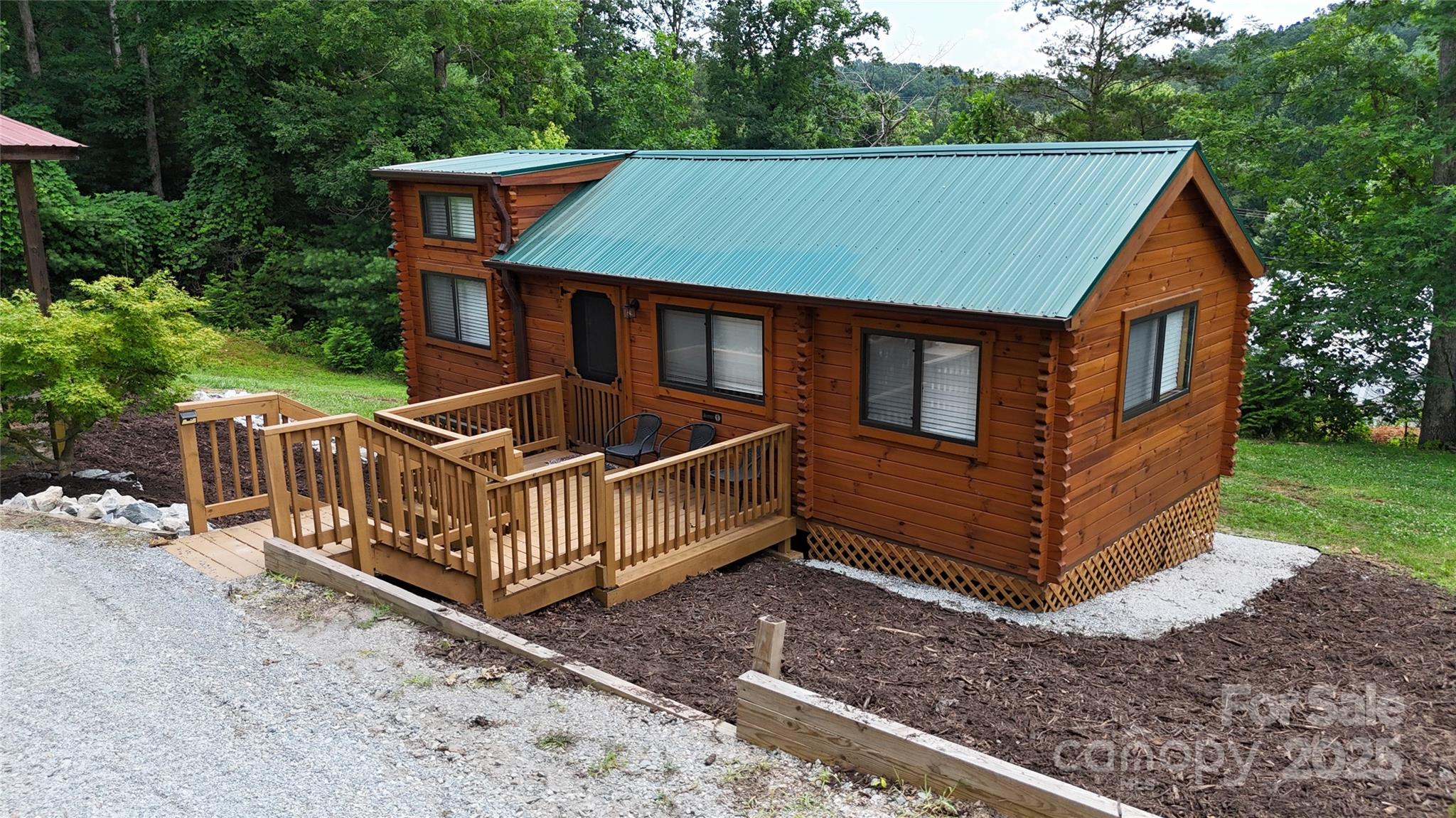 37 Bream Loop Marion, NC 28752 - Photo 2 of 22 a front view of a house with garden and deck