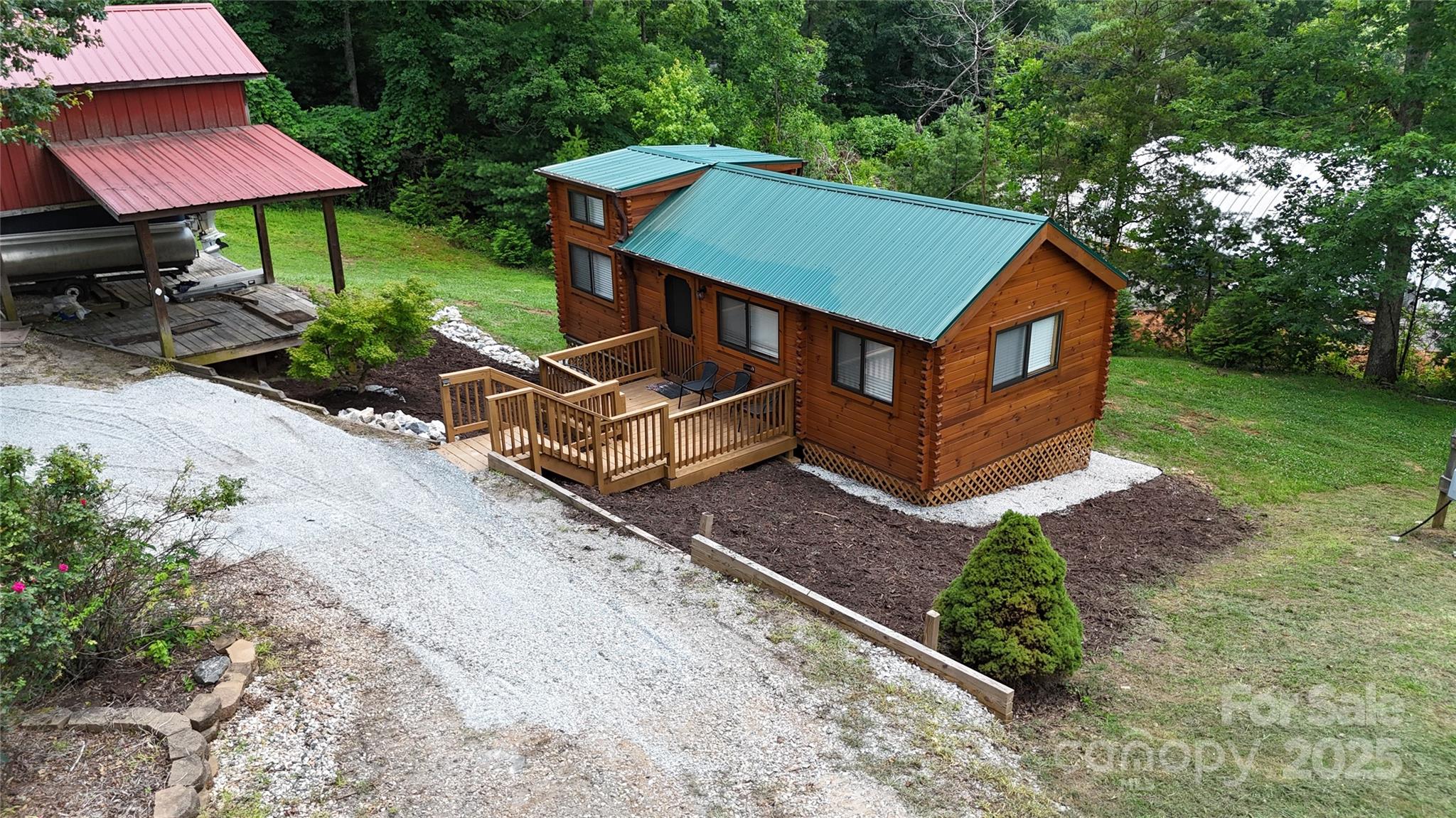 37 Bream Loop Marion, NC 28752 - Photo 3 of 22 an aerial view of a house with table and chairs under an umbrella