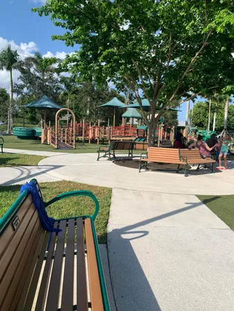 a view of a white house with a big yard and large trees