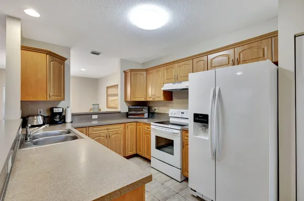 a kitchen with stainless steel appliances a refrigerator sink and cabinets