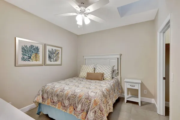 a bedroom with a large bed and a chandelier