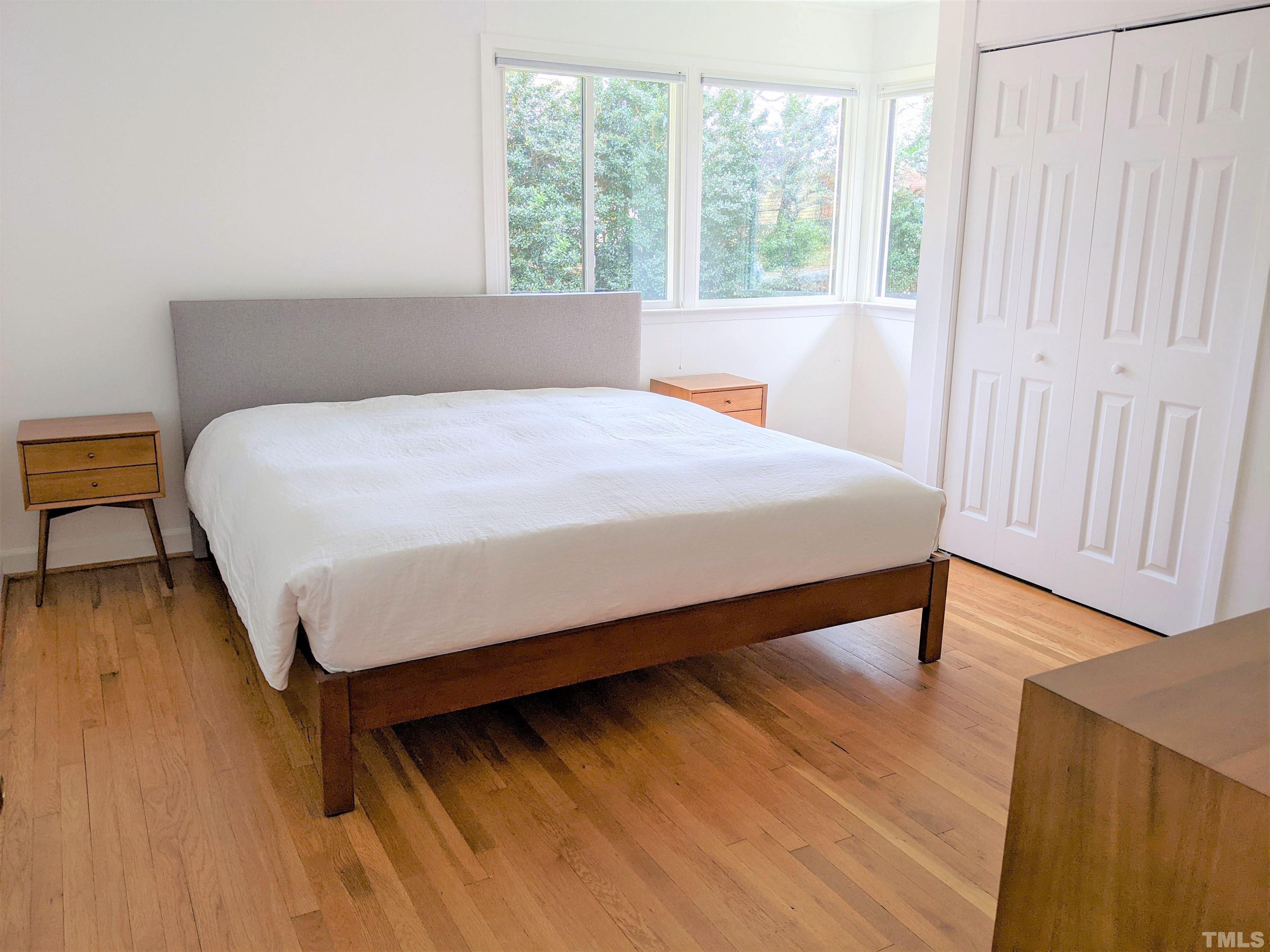 630 Smedes Place Raleigh, NC 27605 - Photo 6 of 9 a bed sitting in a bedroom next to a window