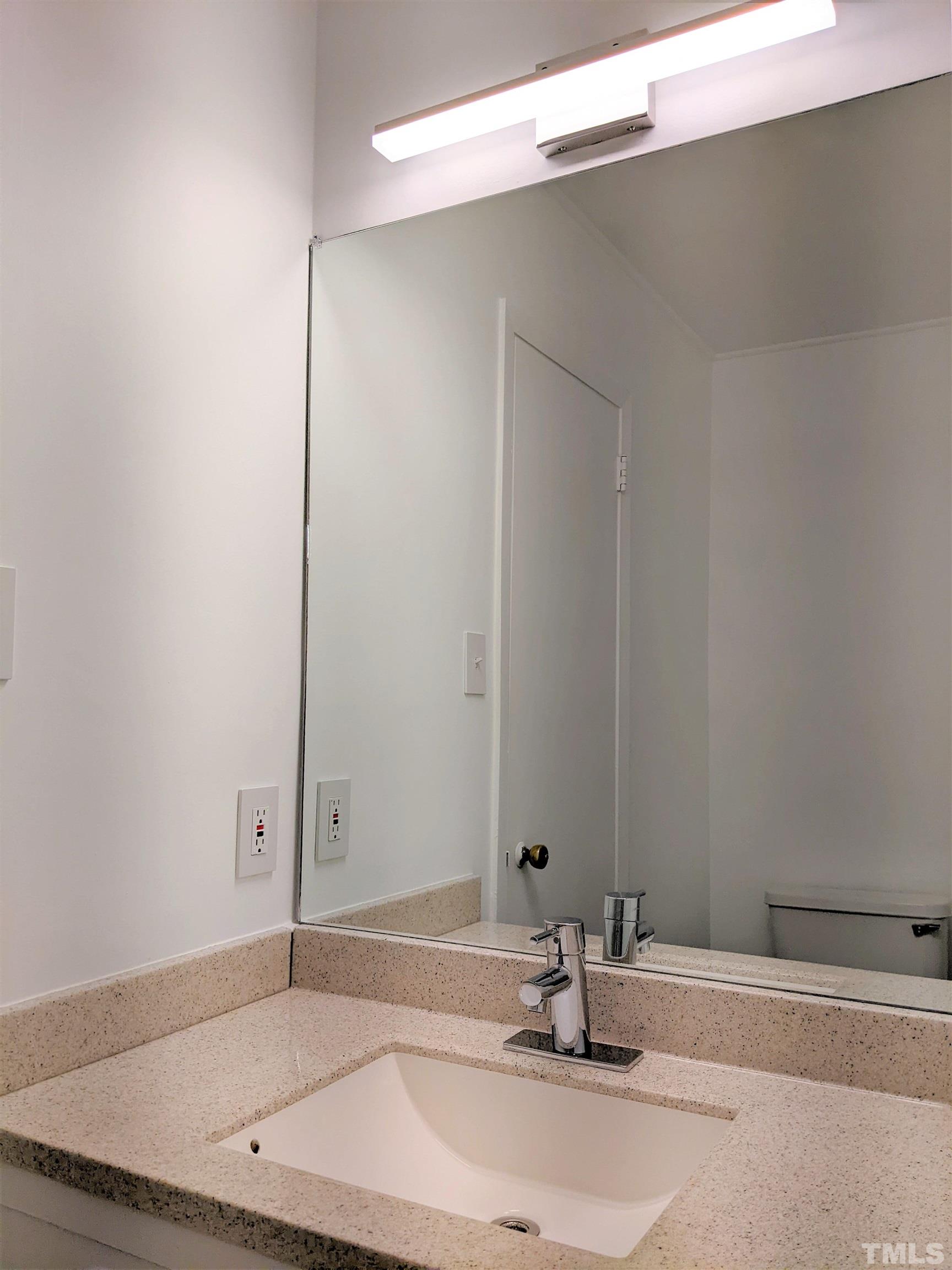 630 Smedes Place Raleigh, NC 27605 - Photo 8 of 9 a bathroom with a sink and a mirror