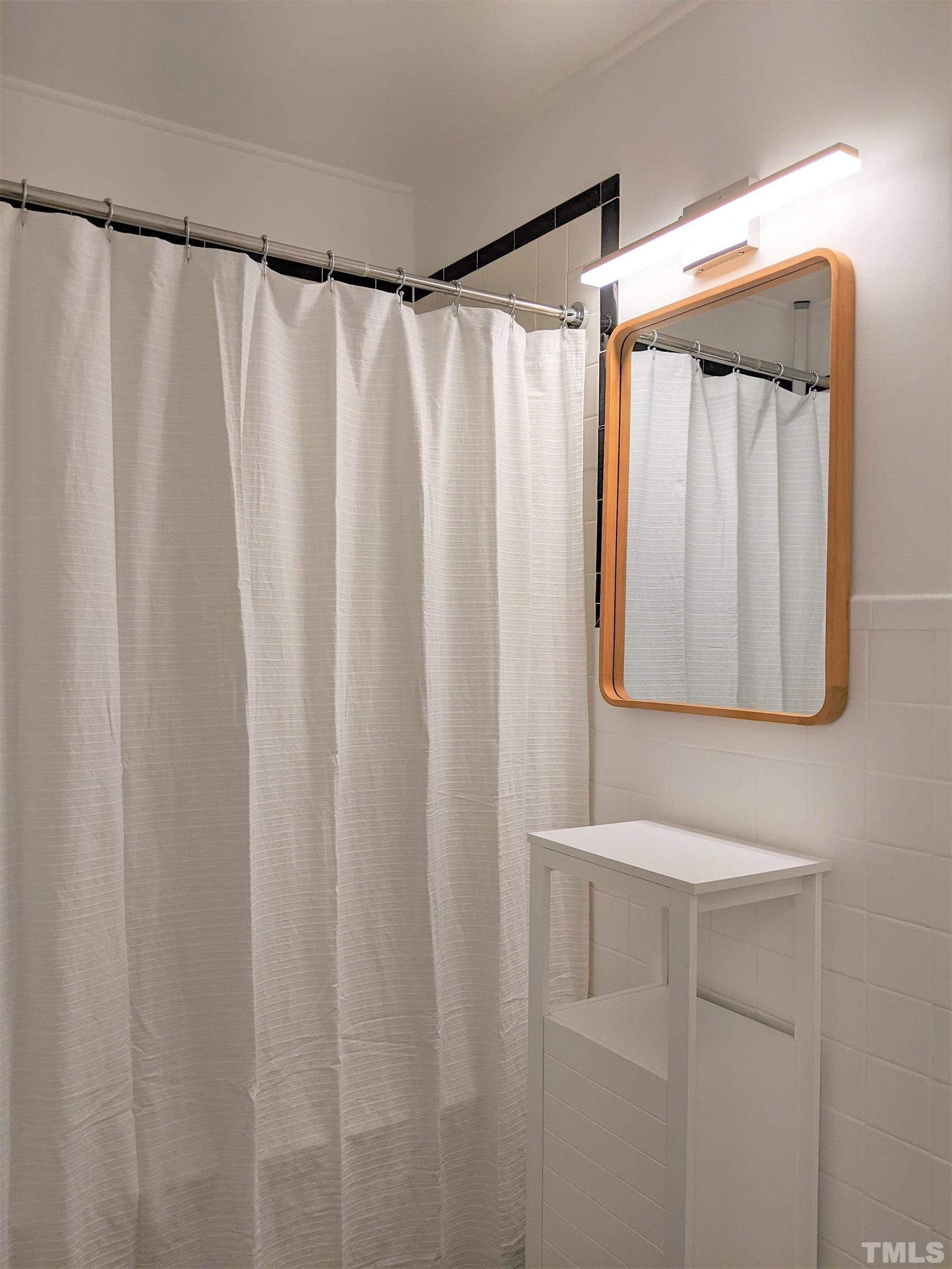 630 Smedes Place Raleigh, NC 27605 - Photo 9 of 9 a bathroom with a shower curtain and a mirror