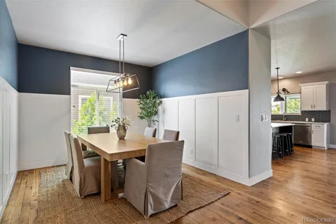 a dining room with furniture a window and kitchen view