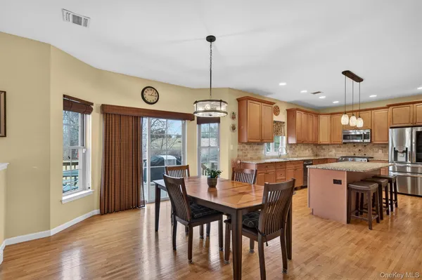 a dining room with furniture and wooden floor