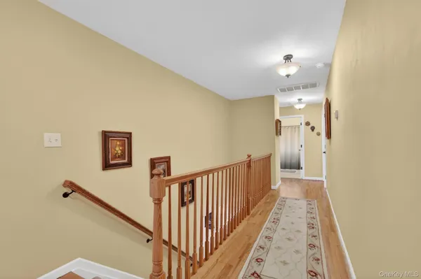 a spacious bedroom with a bed a dresser and a large window