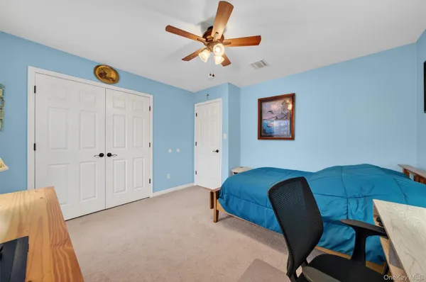 a bedroom with a bed next to a window