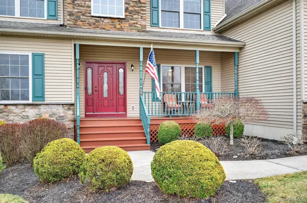 a view of a brick house with potted plants