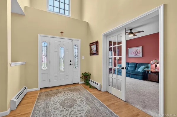 a living room with furniture a ceiling fan and a window