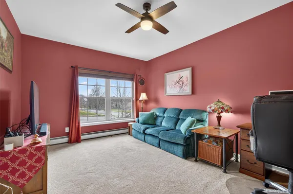 a livingroom with workspace and a window