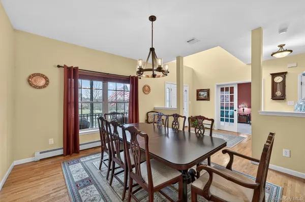 a view of a dining room with furniture window and wooden floor