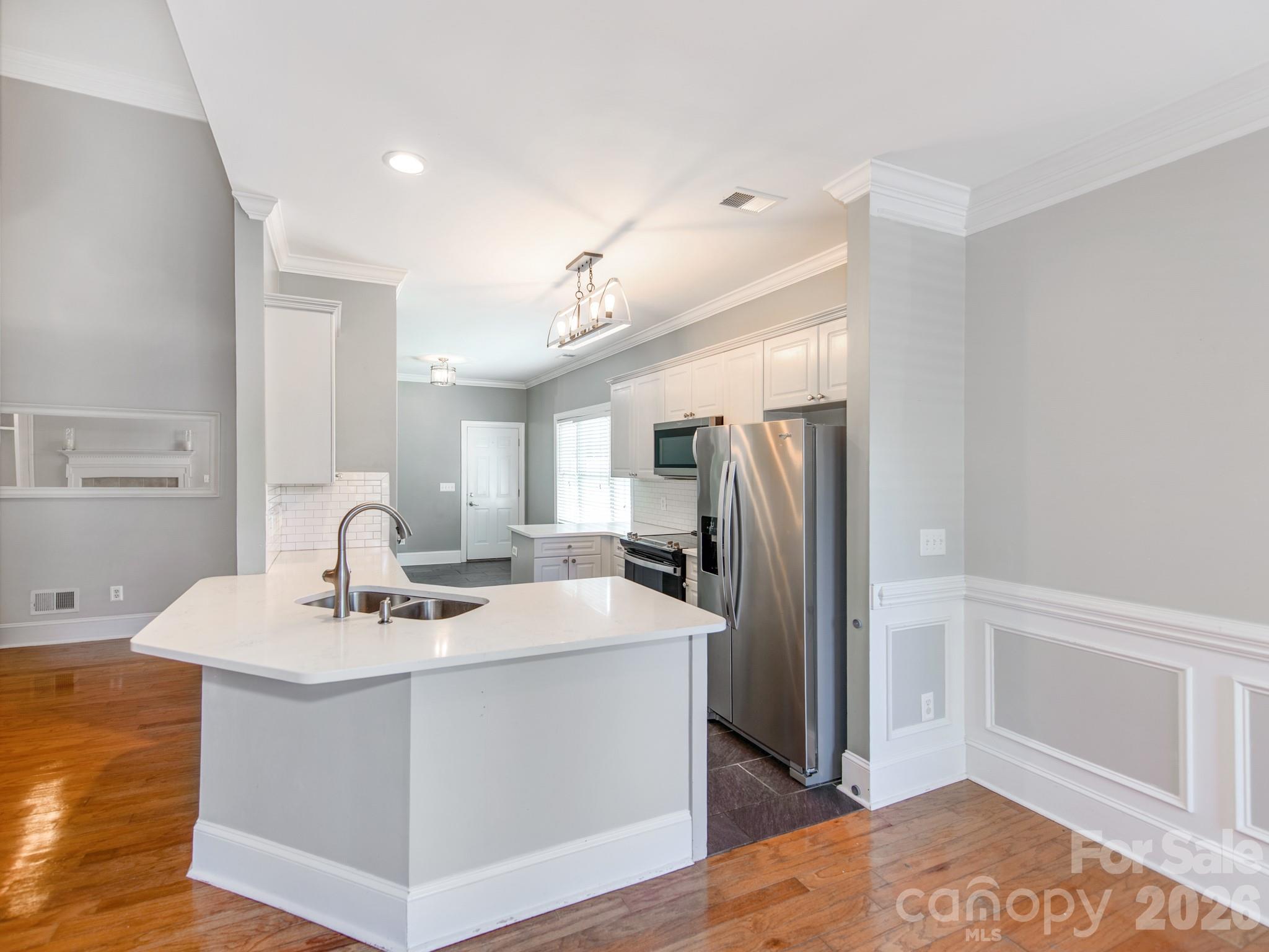 783 Sloan Street Denver, NC 28037 - Photo 7 of 44 a kitchen with stainless steel appliances kitchen island a sink a refrigerator and cabinets