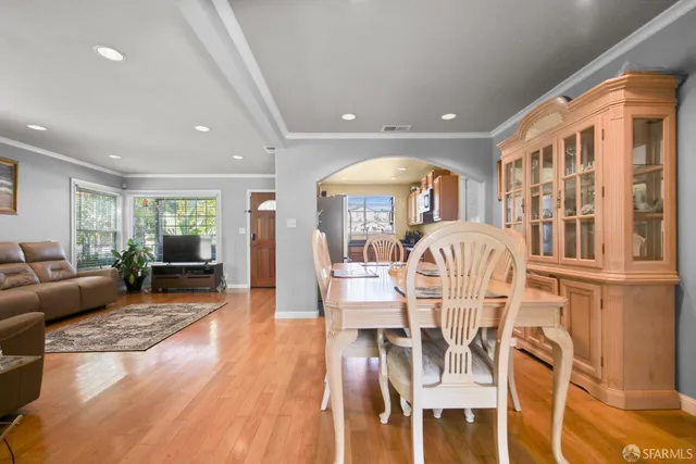 a view of a dining room with furniture window and wooden floor