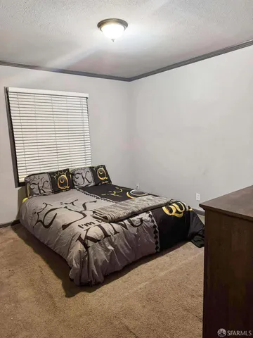 a bed sitting in a bedroom next to a window