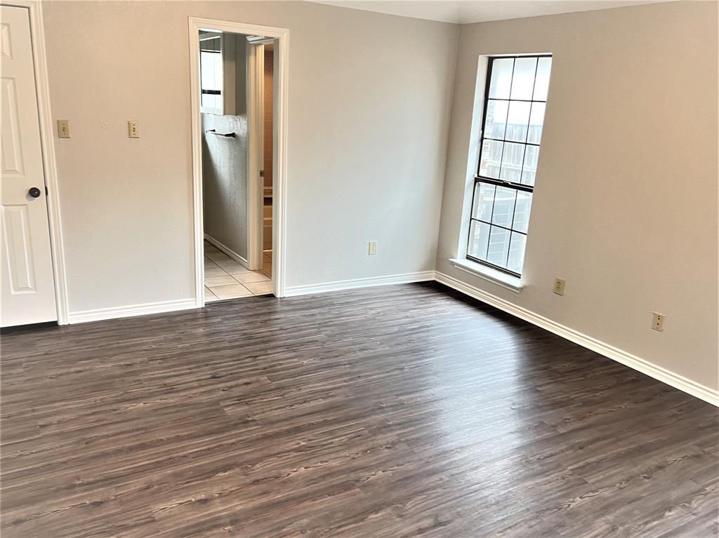 138 East Bethel School Road Coppell, TX 75019 - Photo 12 of 14 an empty room with wooden floor and windows