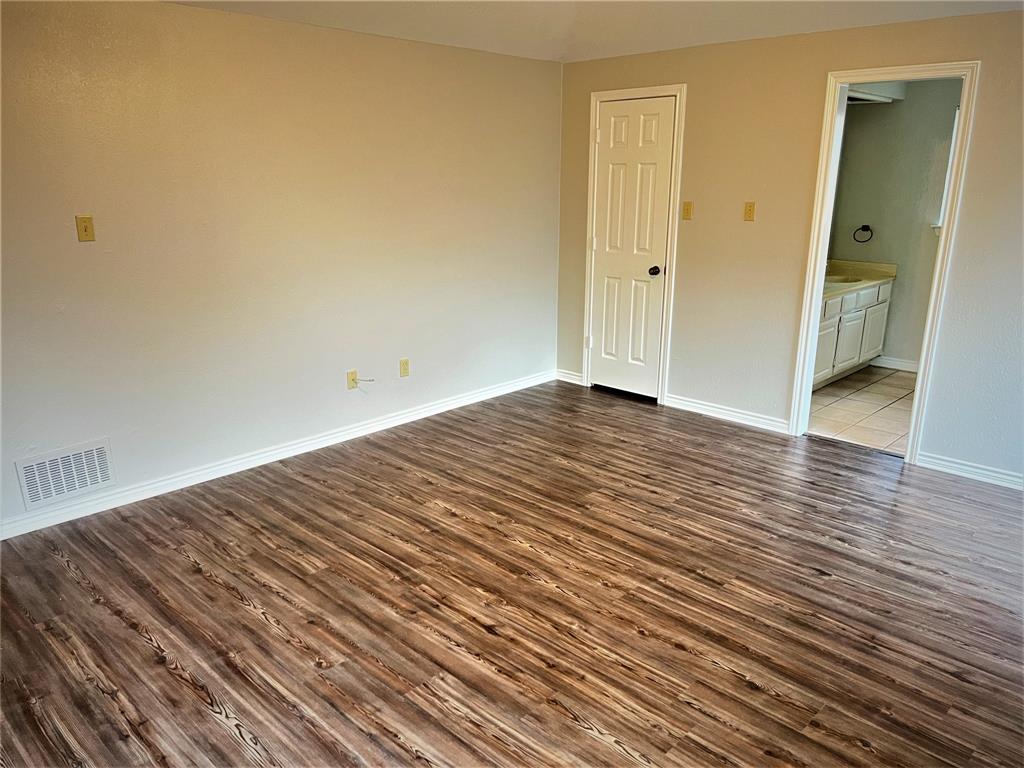 138 East Bethel School Road Coppell, TX 75019 - Photo 13 of 14 a view of a room with wooden floor and a bathroom