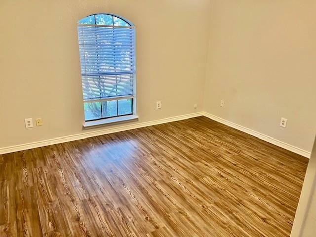 138 East Bethel School Road Coppell, TX 75019 - Photo 3 of 14 an empty room with wooden floor and windows