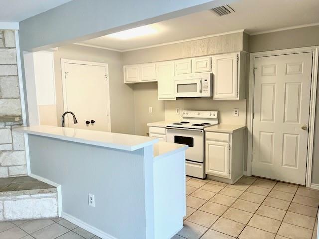 138 East Bethel School Road Coppell, TX 75019 - Photo 9 of 14 a kitchen with white cabinets a sink and appliances