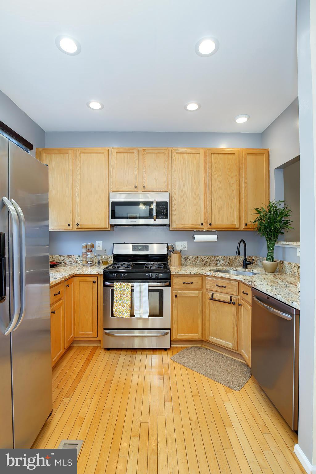 5806 Summers Grove Road Alexandria, VA 22304 - Photo 11 of 30 a kitchen with stainless steel appliances granite countertop a stove a sink and a refrigerator
