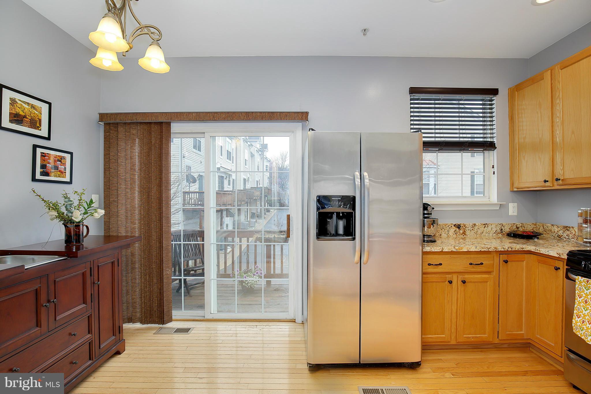 5806 Summers Grove Road Alexandria, VA 22304 - Photo 14 of 30 a kitchen with stainless steel appliances granite countertop a refrigerator a sink dishwasher and wooden cabinets