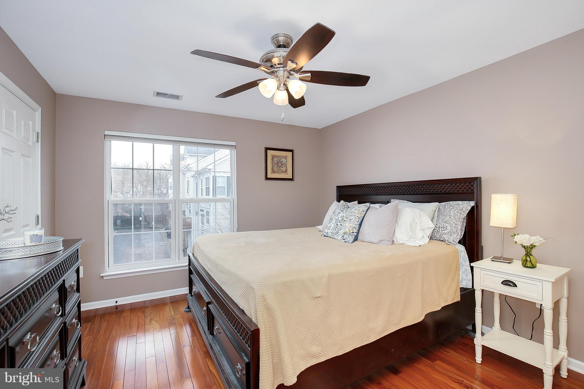 5806 Summers Grove Road Alexandria, VA 22304 - Photo 21 of 30 a bedroom with a large bed and a chandelier