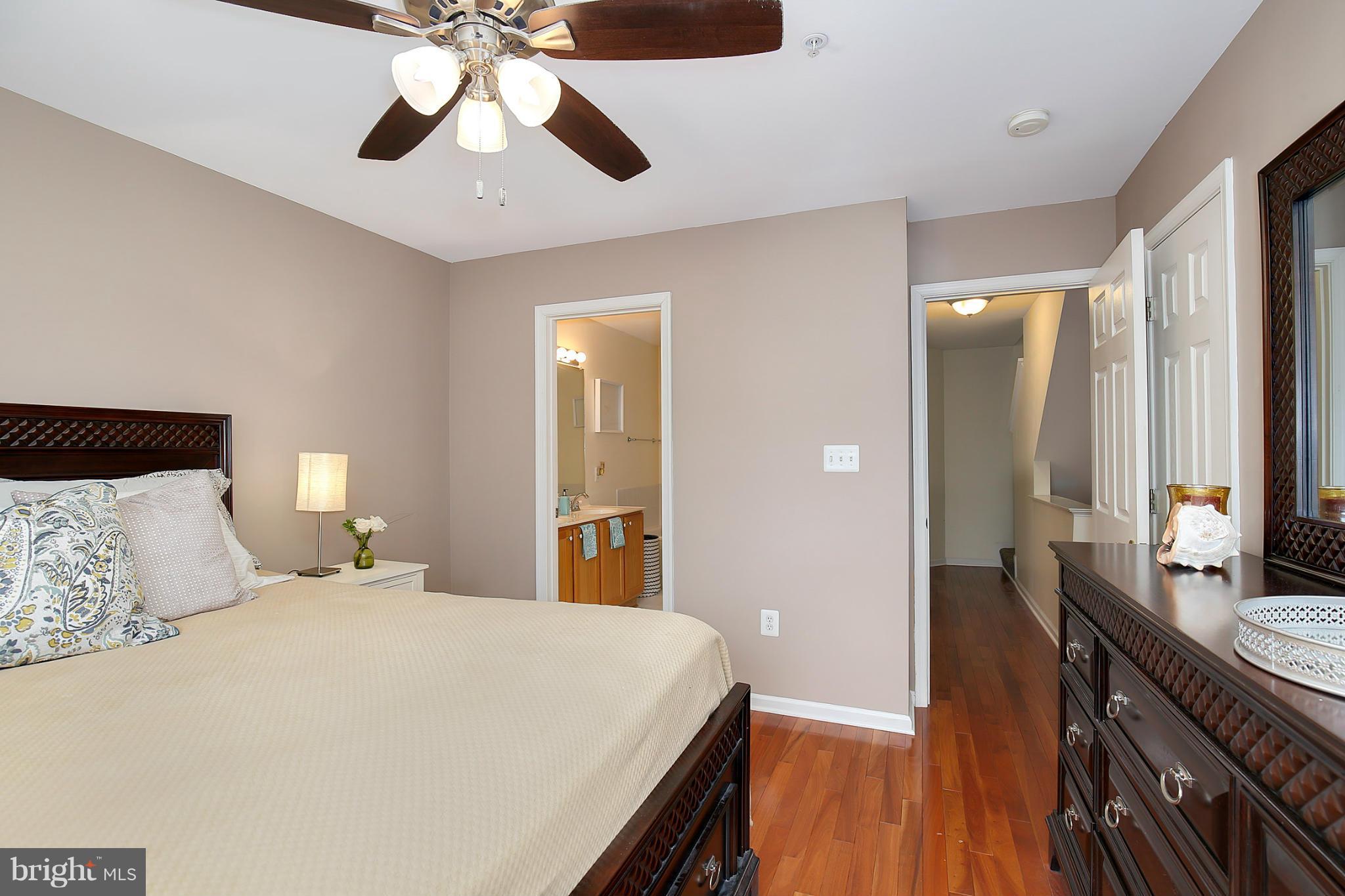 5806 Summers Grove Road Alexandria, VA 22304 - Photo 22 of 30 a bedroom with a bed and a chandelier