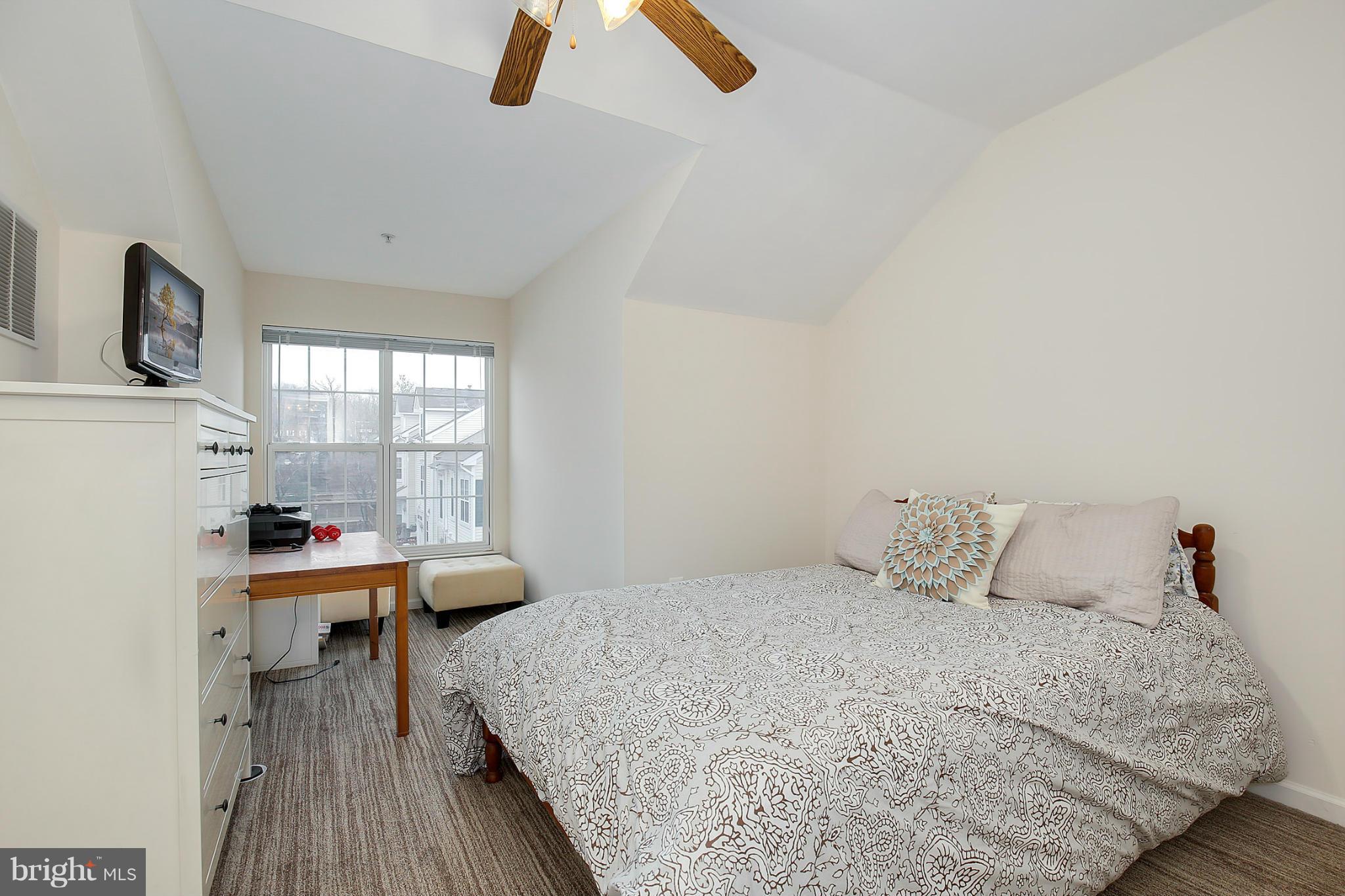 5806 Summers Grove Road Alexandria, VA 22304 - Photo 25 of 30 a bedroom with a bed and large windows