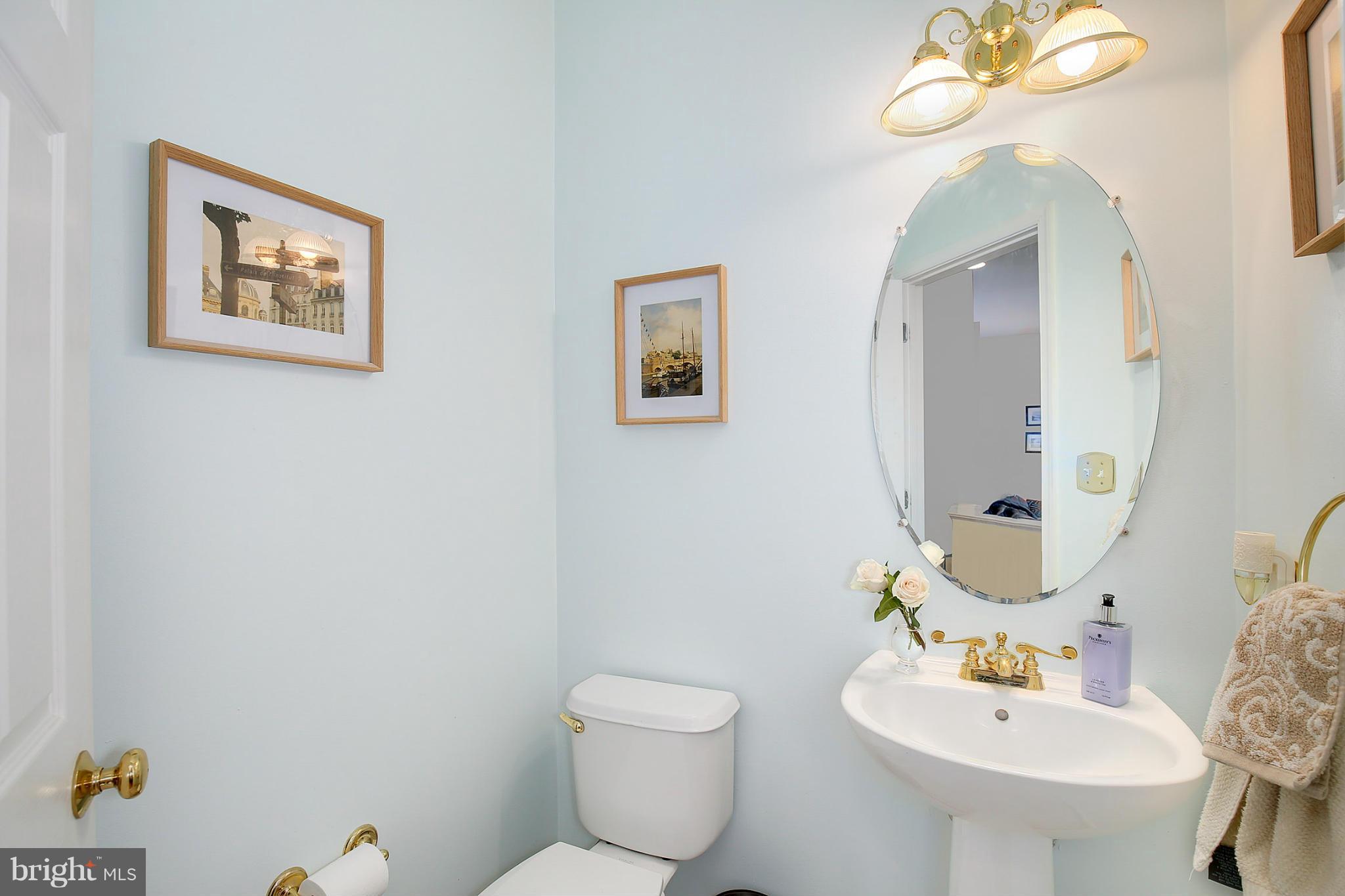 5806 Summers Grove Road Alexandria, VA 22304 - Photo 6 of 30 a bathroom with a toilet sink and mirror