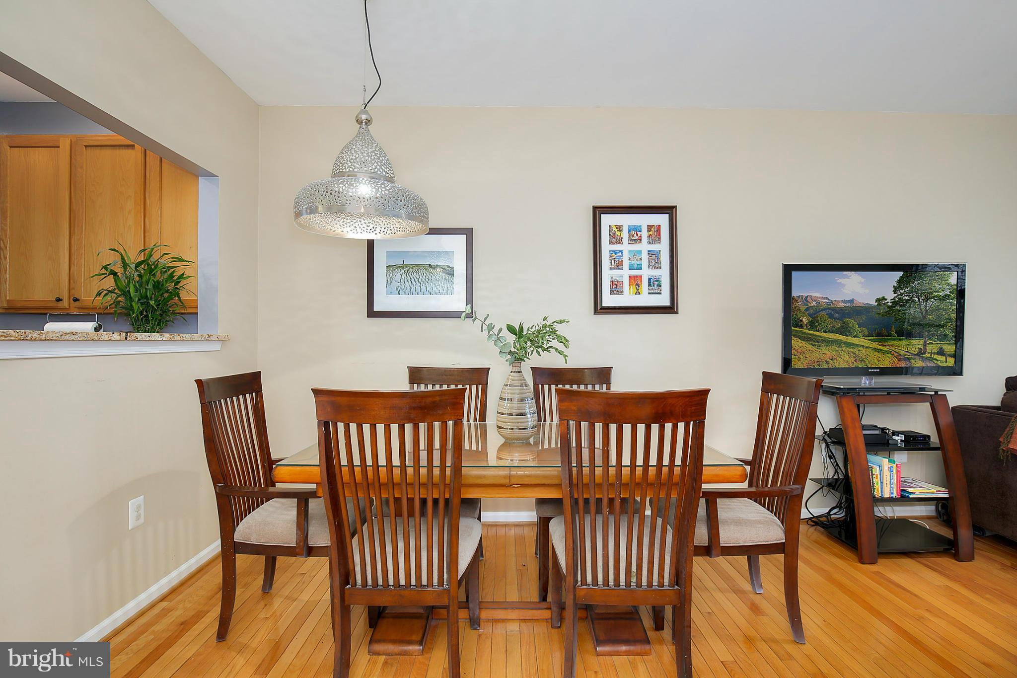 5806 Summers Grove Road Alexandria, VA 22304 - Photo 8 of 30 a view of a dining room with furniture window and wooden floor