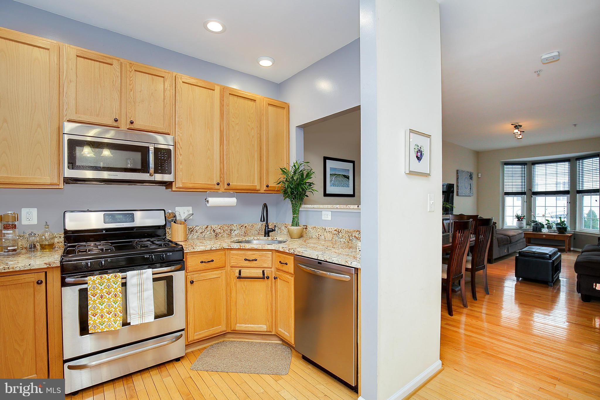 5806 Summers Grove Road Alexandria, VA 22304 - Photo 9 of 30 a kitchen with a stove a sink and a microwave
