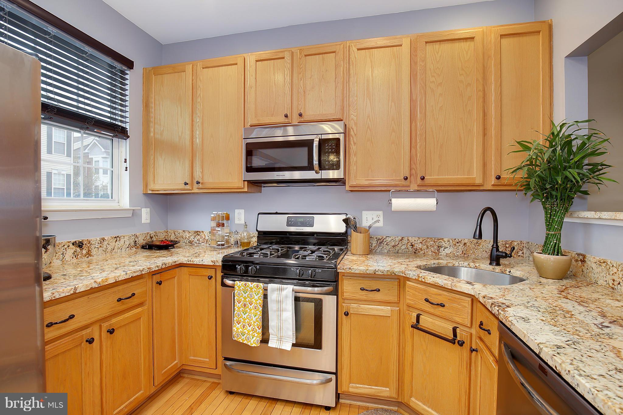 5806 Summers Grove Road Alexandria, VA 22304 - Photo 10 of 30 a kitchen with granite countertop cabinets stainless steel appliances a sink and window