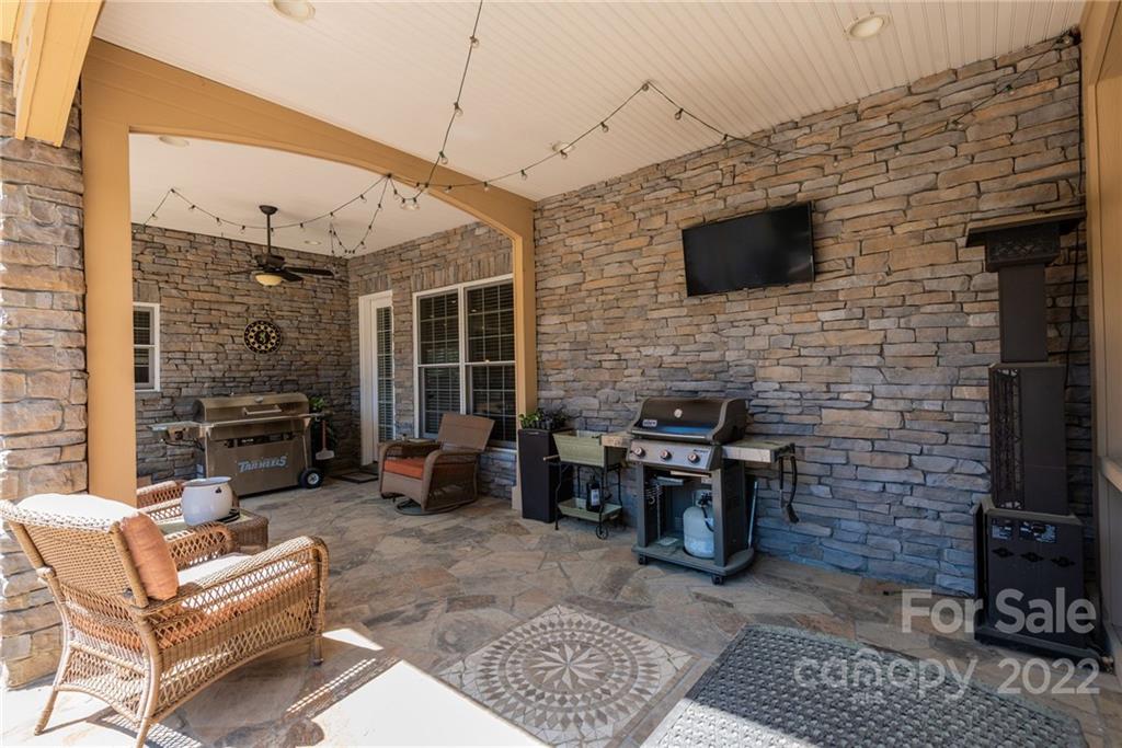 4597 Hickory Nut Ridge Road Granite Falls, NC 28630 - Photo 12 of 48 a backyard of a house with barbeque oven table and chairs