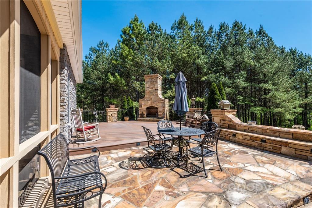4597 Hickory Nut Ridge Road Granite Falls, NC 28630 - Photo 13 of 48 a view of a patio with couches and table and chairs next to a yard