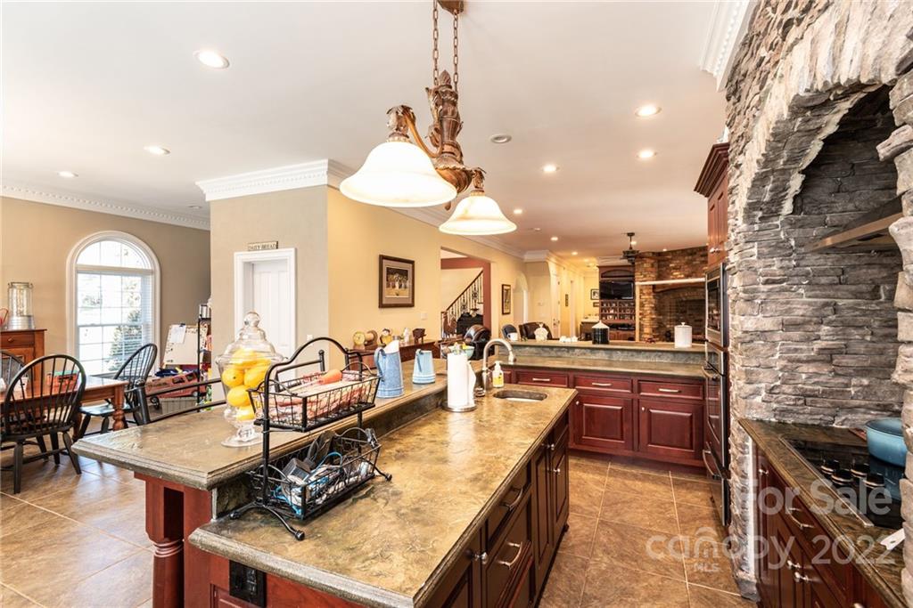 4597 Hickory Nut Ridge Road Granite Falls, NC 28630 - Photo 22 of 48 a kitchen with stainless steel appliances granite countertop a stove and a view of living room
