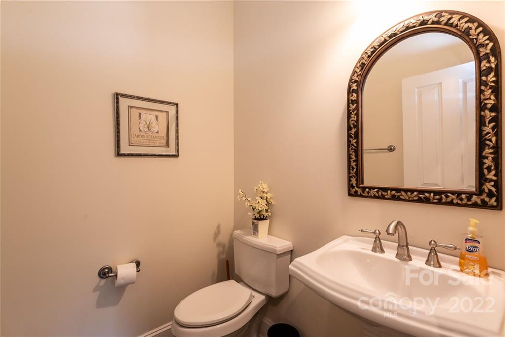 4597 Hickory Nut Ridge Road Granite Falls, NC 28630 - Photo 25 of 48 a bathroom with a toilet a sink and a mirror