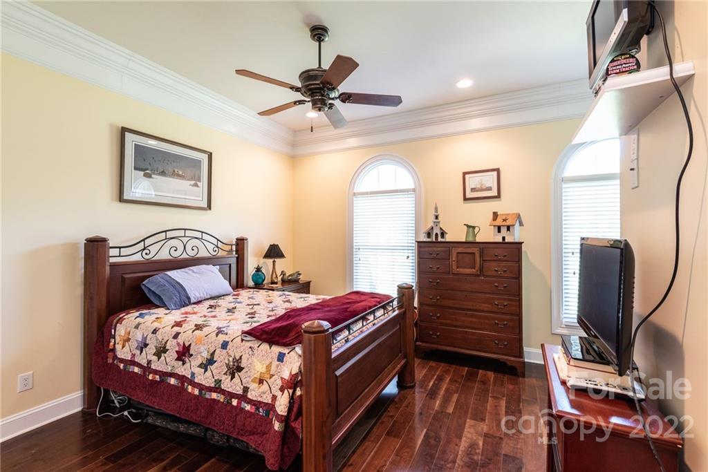 4597 Hickory Nut Ridge Road Granite Falls, NC 28630 - Photo 27 of 48 a bedroom with a bed and wooden floor