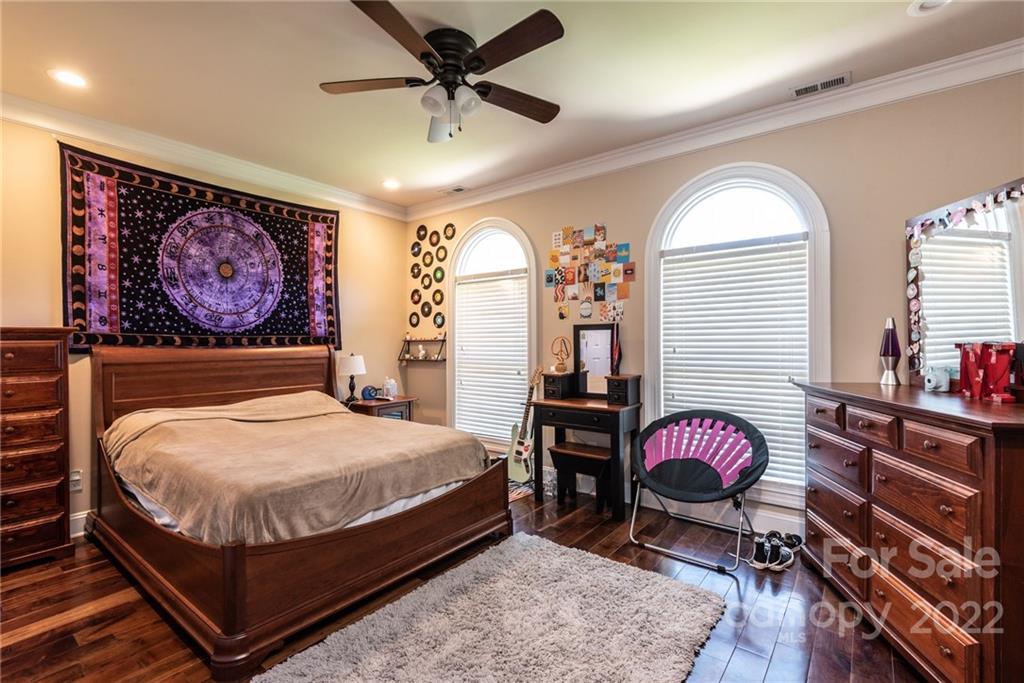 4597 Hickory Nut Ridge Road Granite Falls, NC 28630 - Photo 36 of 48 a bedroom with a bed and a chandelier